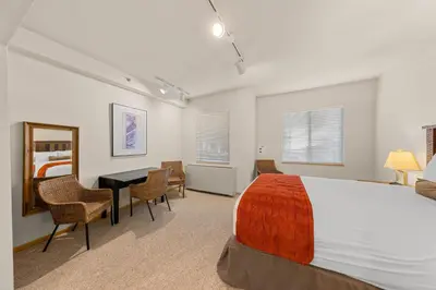 a bedroom with a bed and a table and chairs at Palisades Tahoe Lodge Rentals Studio #152 in Olympic Valley