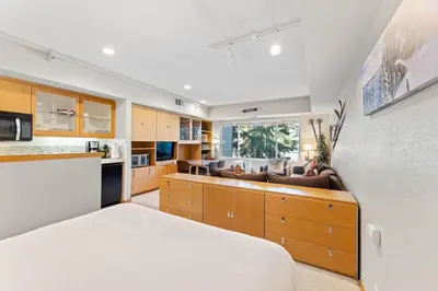 a kitchen with a bed and a living room at Palisades Tahoe Lodge Rentals Studio #207 in Olympic Valley