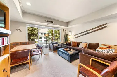 a living room with a couch and a table at Palisades Tahoe Lodge Rentals Studio #207 in Olympic Valley
