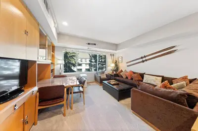 a living room with a couch and a table at Palisades Tahoe Lodge Rentals Studio #207 in Olympic Valley