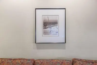 a picture hanging on a wall above a couch at Palisades Tahoe Lodge Rentals Studio #148 in Olympic Valley
