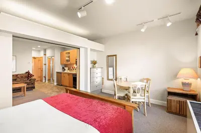 a bedroom with a bed and a dining room at Palisades Tahoe Lodge Rentals Studio #154 in Olympic Valley
