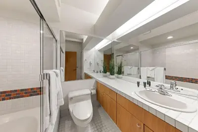 a bathroom with a toilet and a sink and a mirror at Palisades Tahoe Lodge Rentals Studio #205 in Olympic Valley