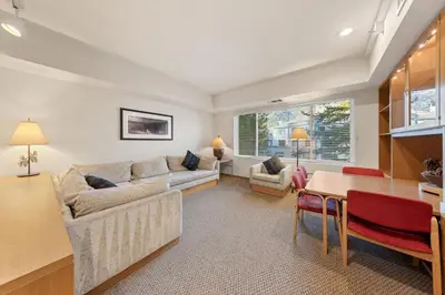 a living room with a couch and a table at Palisades Tahoe Lodge Rentals Studio #205 in Olympic Valley