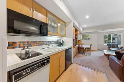 an open kitchen and living room in a home at Palisades Tahoe Lodge Rentals Studio #232 in Olympic Valley