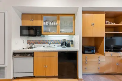 a kitchen with a sink and a microwave at Palisades Tahoe Lodge Rentals Studio #232 in Olympic Valley
