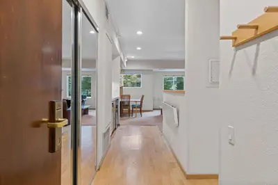 a hallway with a door and a dining room at Palisades Tahoe Lodge Rentals Studio #232 in Olympic Valley