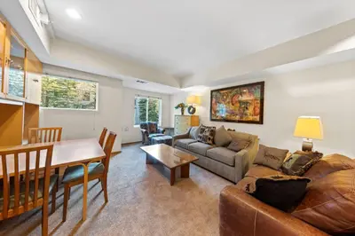 a living room with a couch and a table at Palisades Tahoe Lodge Rentals Studio #232 in Olympic Valley