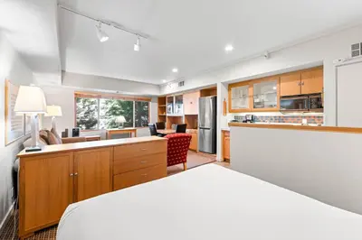 a room with a bed and a kitchen at Palisades Tahoe Lodge Rentals Studio #215 in Olympic Valley