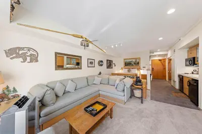 a living room with a couch and a table at Palisades Tahoe Lodge Rentals Studio #214 in Olympic Valley