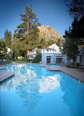 a large pool of blue water in a yard at Palisades Tahoe Lodge Rentals Studio #223 in Olympic Valley