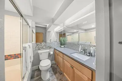 a bathroom with a toilet and a sink and a mirror at Palisades Tahoe Lodge Rentals Studio #226 in Olympic Valley