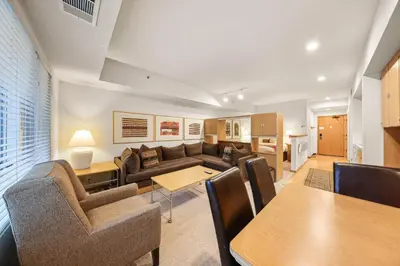 a living room with a couch and a table at Palisades Tahoe Lodge Rentals Studio #234 in Olympic Valley
