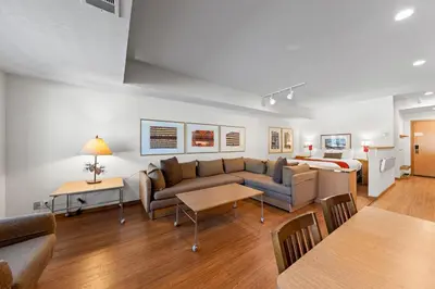 a living room with a couch and a bed at Palisades Tahoe Lodge Rentals Studio #229 in Olympic Valley