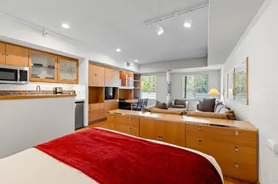 a kitchen with a red rug in a room at Palisades Tahoe Lodge Rentals Studio #229 in Olympic Valley