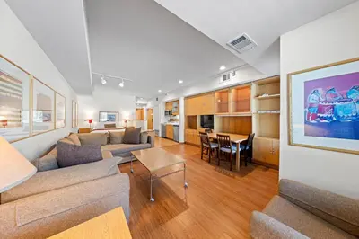 a living room with a couch and a dining room at Palisades Tahoe Lodge Rentals Studio #229 in Olympic Valley