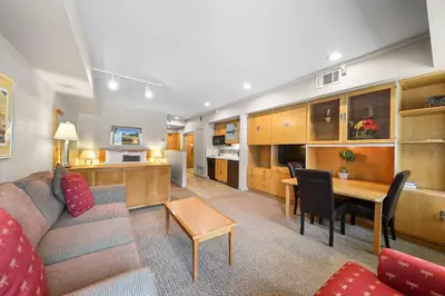 a living room with a couch and a table at Palisades Tahoe Lodge Rentals Studio #237 in Olympic Valley