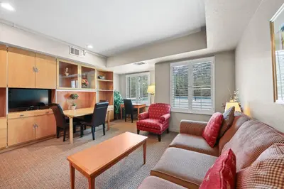 a living room with a couch and a table at Palisades Tahoe Lodge Rentals Studio #237 in Olympic Valley