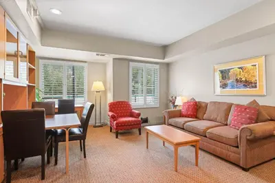 a living room with a couch and a table at Palisades Tahoe Lodge Rentals Studio #237 in Olympic Valley