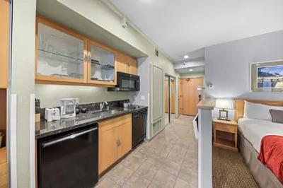 a hotel room with a bed and a kitchen at Palisades Tahoe Lodge Rentals Studio #238 in Olympic Valley