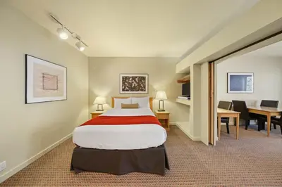 a hotel room with a bed and a desk at Palisades Tahoe Lodge Rentals Studio #250 in Olympic Valley