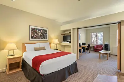 a hotel room with a bed and a dining room at Palisades Tahoe Lodge Rentals Studio #250 in Olympic Valley