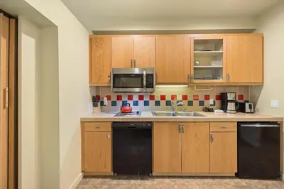 a kitchen with a sink and a microwave at Palisades Tahoe Lodge Rentals Studio #250 in Olympic Valley