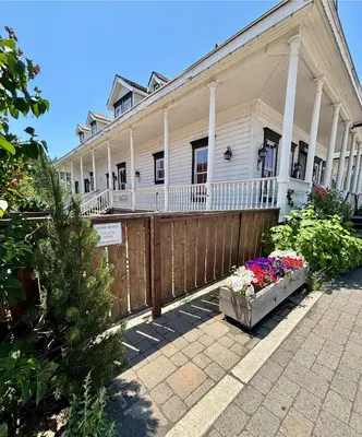 a white house with a fence and flowers in front of it at Tahoe Star Hotel in Truckee