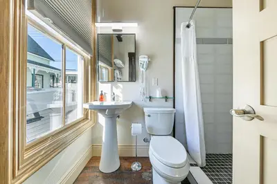 a bathroom with a toilet and a sink and a window at Tahoe Star Hotel in Truckee