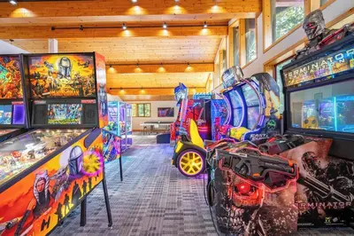 a room filled with lots of pinball machines at Slope Side Studio in Northstar Village! in Truckee