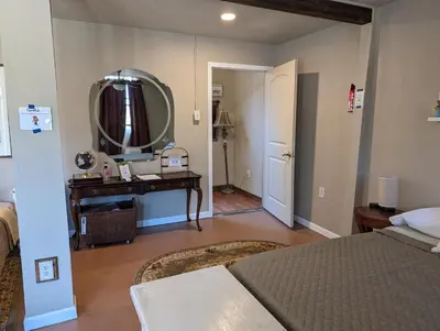 a bedroom with a bed and a mirror on the wall at Rustic Rooms Barn Loft (Upstairs Studio Apartment) Near Kings Canyon & Sequoia National Parks in Squaw Valley