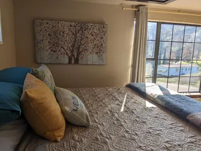 a bedroom with a bed with pillows and a window at Rustic Rooms Barn Loft (Upstairs Studio Apartment) Near Kings Canyon & Sequoia National Parks in Squaw Valley