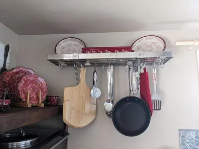 a kitchen rack with pots and pans and utensils at Rustic Rooms Barn Loft (Upstairs Studio Apartment) Near Kings Canyon & Sequoia National Parks in Squaw Valley