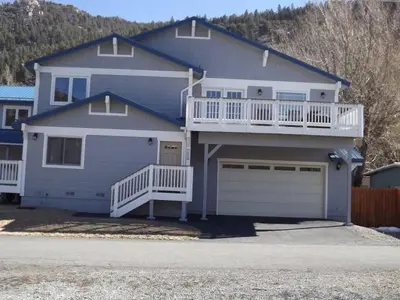 a blue house with a balcony and a garage at Rr-johnson Suite in June Lake