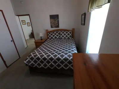 a bedroom with a bed with a black and white comforter at Rr-kenton Hs in June Lake