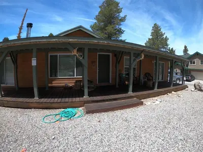 a house with around porch with a deck at Rr-kenton Hs in June Lake