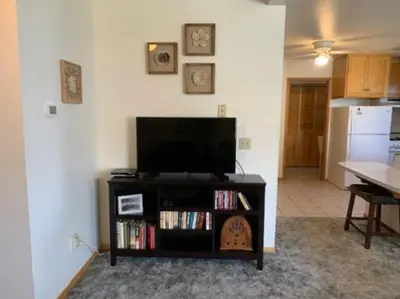 a living room with a flat screen tv on a entertainment center at Rr-june Lake Lodge in June Lake
