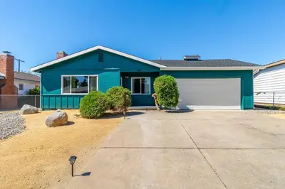 a blue house with a white garage at Reno Serenade: 3-Bed Urban Sanctuary in Reno
