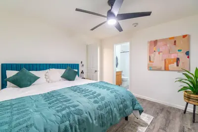 a bedroom with a bed with a ceiling fan at Midtown Modern - Stylish 2BR Lodging in Reno in Reno