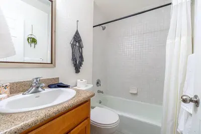a bathroom with a sink and a toilet and a tub at Midtown Modern - Stylish 2BR Lodging in Reno in Reno