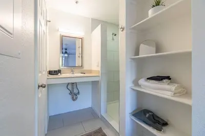 a bathroom with a shower and a sink and a mirror at Midtown Modern - Stylish 2BR Lodging in Reno in Reno