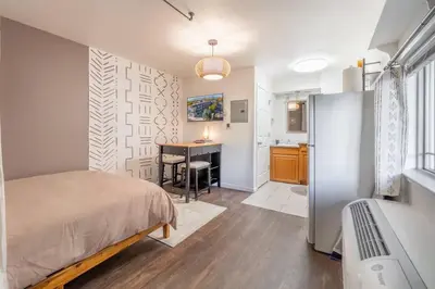 a bedroom with a bed and a desk in a room at Midtown Getaway: Trendy Studio Heart of Reno in Reno