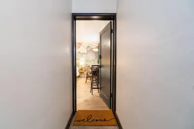 a hallway with a door leading to a dining room at Riverside Glam: Stylish Urban Escape in Reno