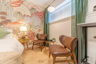 a bedroom with a mural on the wall at Riverside Glam: Stylish Urban Escape in Reno