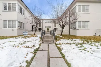 a white building with snow in front of it at Riverside Luxe: Stylish Designer Retreat in Reno
