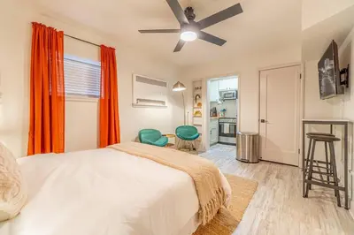 a bedroom with a bed and a ceiling fan at Riverside Luxe: Stylish Designer Retreat in Reno