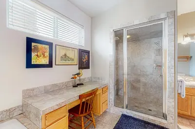 a bathroom with a shower and a desk with a chair at Rooftop Retreat in South Lake Tahoe