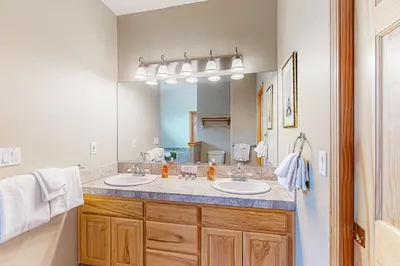 a bathroom with two sinks and a large mirror at Rooftop Retreat in South Lake Tahoe