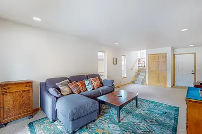 a living room with a blue couch and a table at Rooftop Retreat in South Lake Tahoe