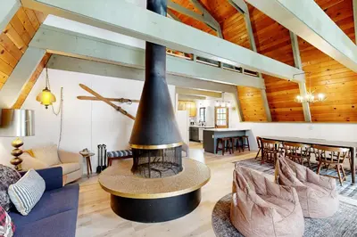 a living room with a large fireplace in a house at Groovy Days Chalet in Arnold